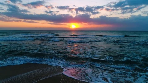 Aerial view of beautiful sunrise with dramatic cloudscape over the sea video Stock Footage 84220524