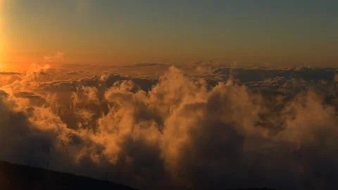 Aerial view of a beautiful sunset over a sea of rolling clouds in Waikamoi Stock Footage 337240247