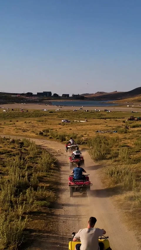 Aerial View Behind Atvs By Lake Mountain Vertical Video Vídeos de archivo 334877166