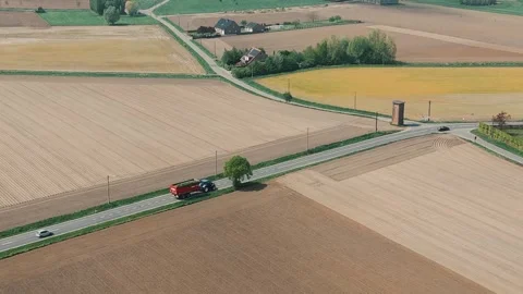 Aerial View of Belgian Spring Fields with Farmhouses and Tractor Stock Footage 307939378