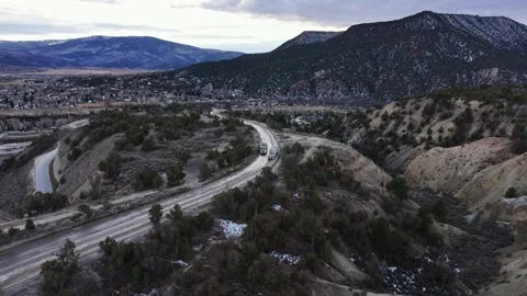 Aerial view of belly dump trucks navigating a road in Gypsum, United States. Stock Footage 339998933