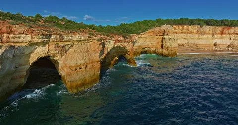Aerial view of Benagil Cave, viewed through the circular cliff-top hole Algarve Vídeos de archivo 311032413