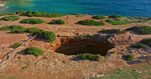 Aerial view of Benagil Cave, viewed through the circular cliff-top hole Algarve 스톡 동영상 311802859