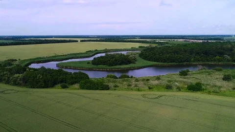 Aerial View. Bend Of The River Bends Around The Magnificent Wood, In The Middle Stock Footage 76622976