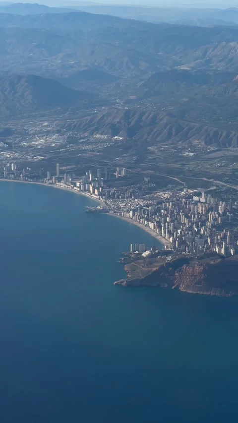 Aerial view of Benidorm city surrounded by mountainous terrain. Vertical Stock Footage 294103165