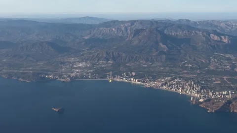 Aerial view of Benidorm with iconic skyline surrounded by mountainous terrain Stock Footage 294103166