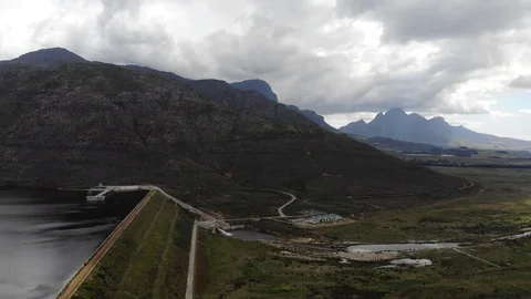 Aerial view of the berg river dam wall in the mountains with water outlet and Stock-Footage 100925479