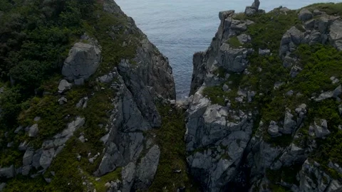 Aerial view between of the cliffs next to sea Stock Footage 162640503