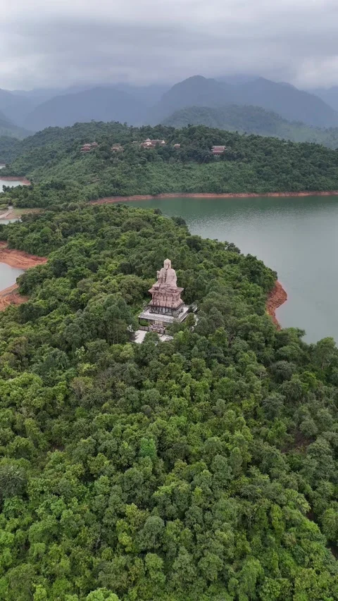 Aerial View of Big Buddha Statue on Lush Green Peninsula in Hue, Vietnam Video stock 335835885