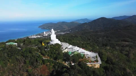 Aerial view of big buddha statue in phuket on hilltop overlooking turquoise Stock Footage 344086252