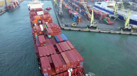 Aerial view of big cargo ship docking at the pier Stock Footage 43544418