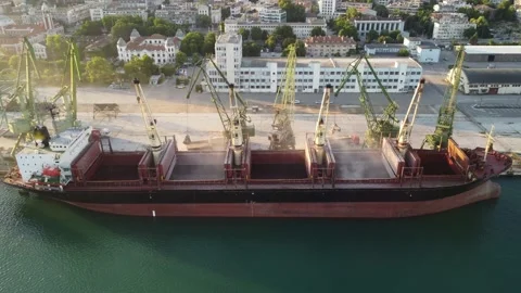 Aerial view of big cargo ship bulk carrier is loaded with grain of wheat in port Stock Footage 197805949