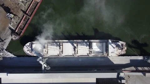 Aerial view of big cargo ship bulk carrier is loaded with minerals in port Video stock 219938139