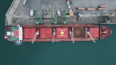 Aerial view of big cargo ship bulk carrier is loaded with grain of wheat in port Stock Footage 222935543