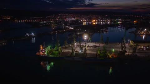 Aerial view of big cargo ship bulk carrier in port at night Stock Footage 225725973