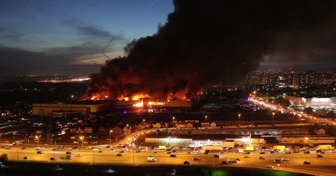 Aerial view of a big fire in the mall many firefighters try to fight the fire Video stock 80865417
