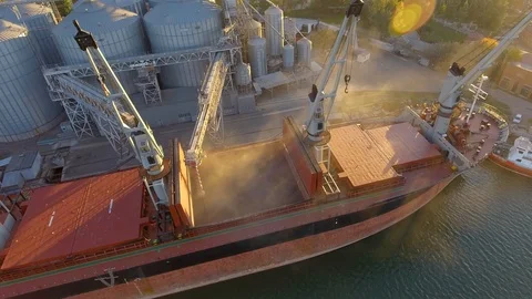 Aerial view of big grain elevators on the sea. Loading of grain on a ship. Port Stock Footage 99205453