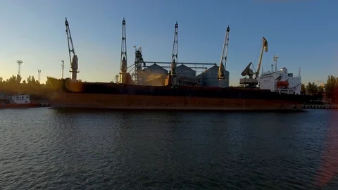 Aerial view of big grain elevators on the sea. Loading of grain on a ship. Port Stock Footage 99205741