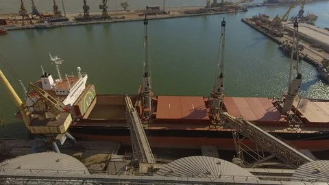 Aerial view of big grain elevators on the sea. Loading of grain on a ship. Port Stock Footage 99205798