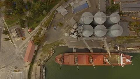Aerial view of big grain elevators on the sea. Loading of grain on a ship. Port Stock Footage 99205872