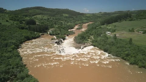 Aerial view of a big river flowing into a waterfall. Salto Saudades. 4K. Stock Footage 233219740