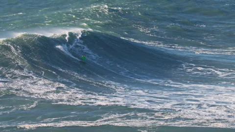 Aerial view of a big wave surfer on a big wave in Nazare surfing spot, Portugal Stock Footage 306762645