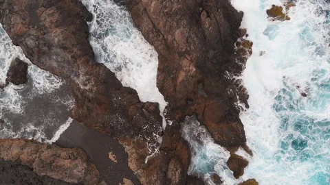 Aerial view - big waves break on the rocky coast of the Atlantic Ocean. A lot of Stock Footage 112034564