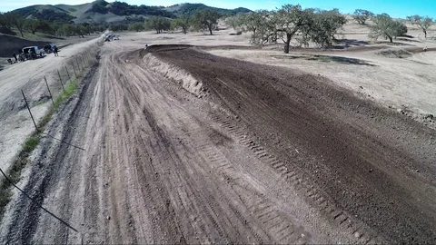 Aerial view of a biker doing a trick jump on a desert race track Video stock 92106343