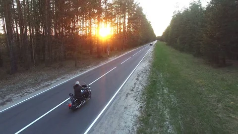 Aerial view of a biker riding a forest road, shot drone 動画素材 107657087
