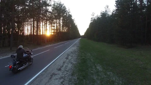 Aerial view of a biker riding a forest road, shot drone 動画素材 107657110
