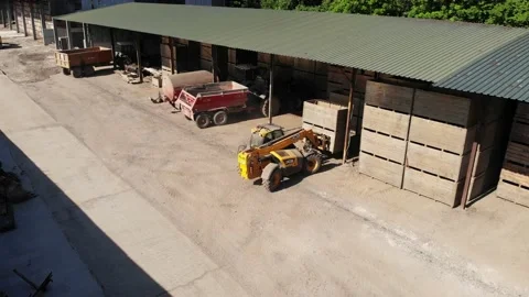 Aerial view of bins empty bins being stacked on a farm yard Stockbeeldmateriaal 156722883