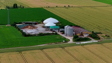 Aerial View of Biogas Facility Amid Green and Golden Farmland Stock Footage 339766536