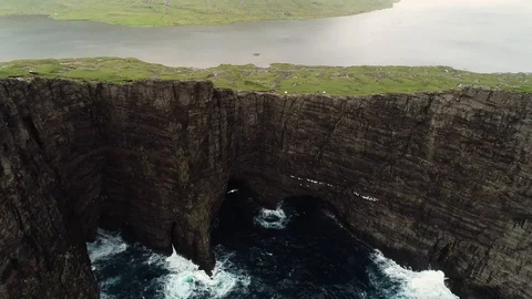 Aerial view of bird flying around foggy English Slave cliff, Faroe island. Stock Footage 102132841