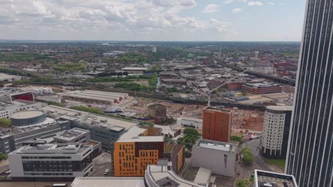 Aerial view of Birmingham redevelopment with trains, construction and growing Stock Footage 334691580