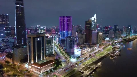 Aerial view of Bitexco Tower, buildings, roads, Thu Thiem 2 bridge and Saigon Stock Footage 201922109