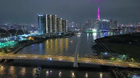 Aerial view of Bitexco Tower, buildings, roads, Thu Thiem 2 bridge and Saigon Stock Footage 201922358