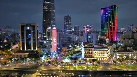 Aerial view of Bitexco Tower, buildings, roads, Thu Thiem 2 bridge and Saigon Stock Footage 201922473