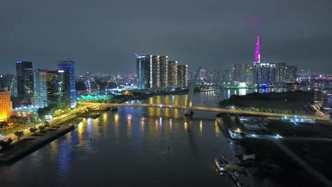 Aerial view of Bitexco Tower, buildings, roads, Thu Thiem 2 bridge and Saigon Stock Footage 201922478