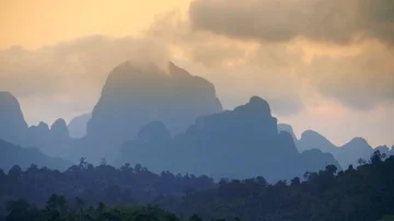 Aerial view of bizarre mountains covered with tropical forest. Sunset cloudy sky Stock Footage 85841996