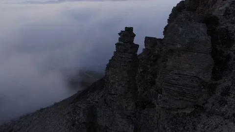 Aerial view of a bizarre rock. The distant shot is obscured by fog. Stock Footage 150584222