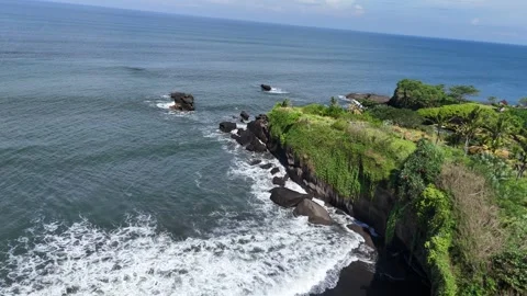 Aerial view of black sand beach next to rice fields in Bali, Indonesia Stock Footage 320514542