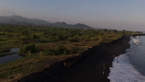 Aerial View of Black Sand Beach with Mountains, Bali Video stock 337606974