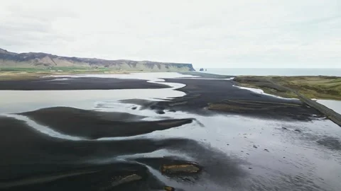 Aerial view of black sand river channels on Iceland coast 4K Stock-Footage 343869711