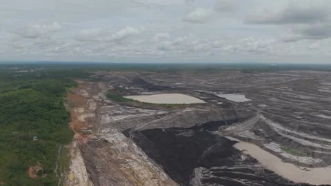 Aerial view of blackened coal in a mining pit Stock Footage 332600336