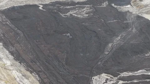Aerial view of blackened coal in a mining pit Stock Footage 332600377