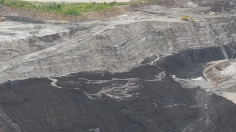 Aerial view of blackened coal in a mining pit Stock Footage 332600385