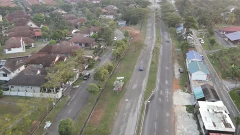 Aerial view of blue car moving on the road in Desa Pinggiran Putra Stock Footage 150747041