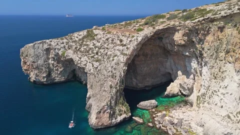 Aerial view of Blue Grotto cliffs and limestone arch over turquoise water Stock Footage 337000656