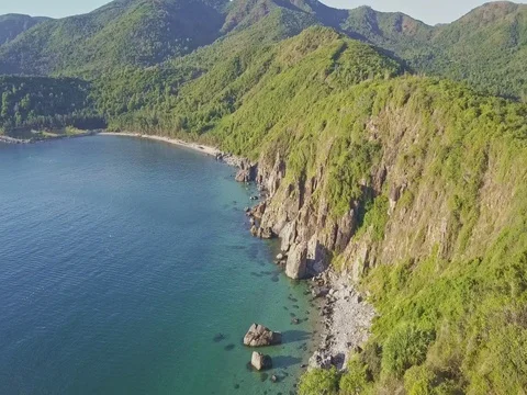 Aerial View Blue Ocean and Green Hilly Rocky Coast Stock Footage
