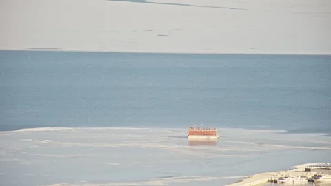 Aerial View of Blue Ocean with Floating Ice and Orange Roof House 스톡 동영상 326414622